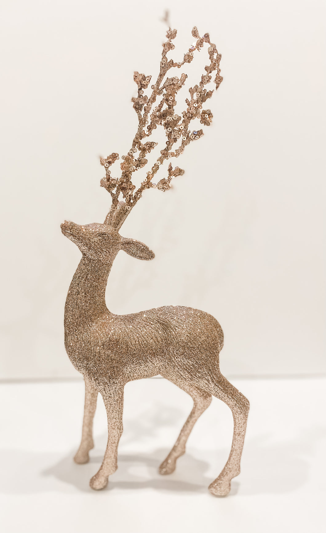 Blush deer with tall antlers